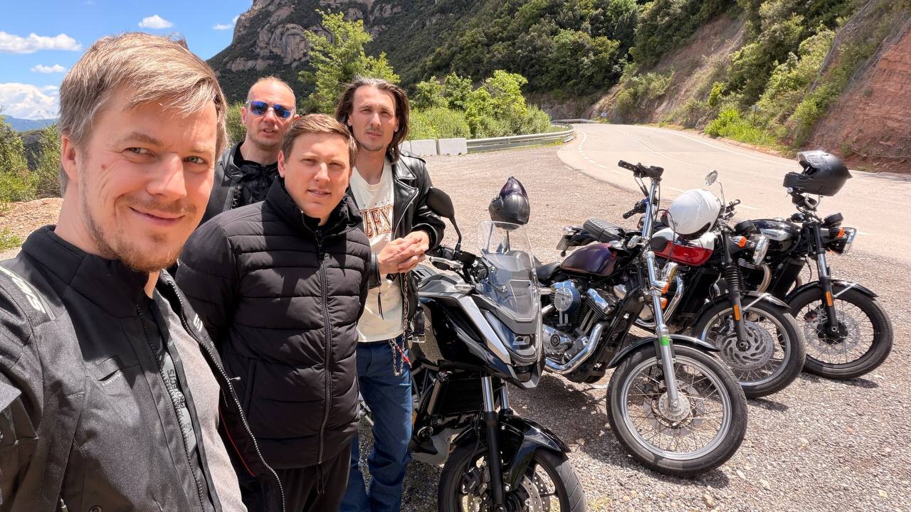 MotoBarna riders and motorcycles stopped on a mountain road in Catalunya